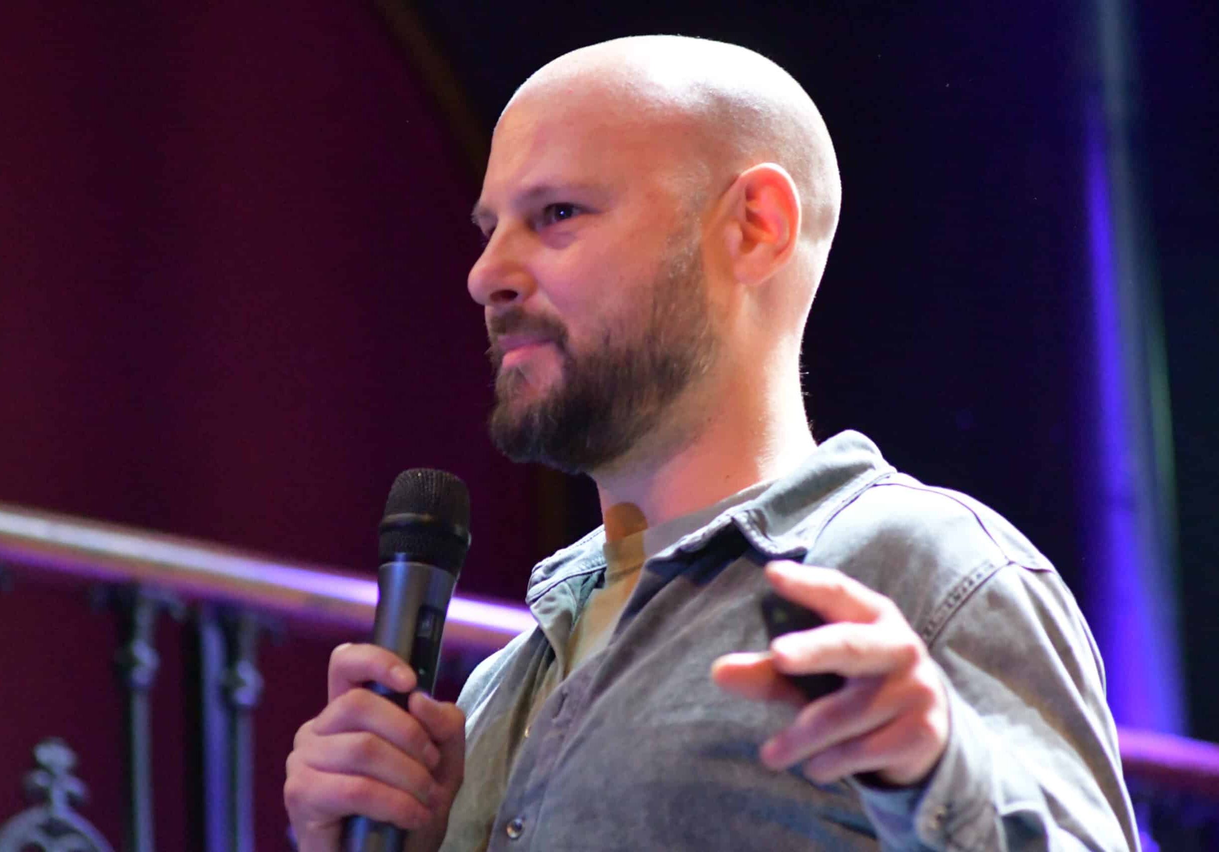 Dan B presenting with microphone