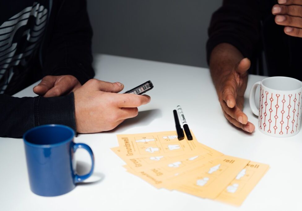 Hands mugs and leaflets (no faces shown)